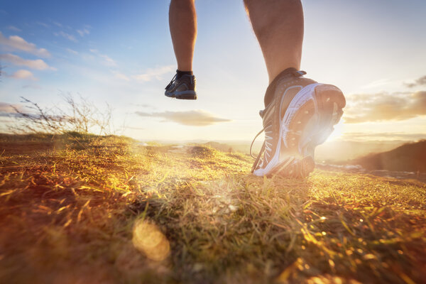 Image of feet running through field 