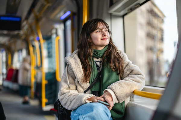 A lady looking out of the window on bus