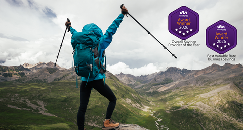 Person celebrating reaching top of mountain